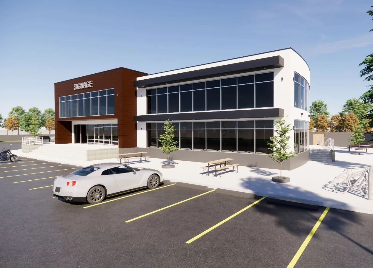 Two-storey office new build with a curved curtain-wall corner, signage tower and parking